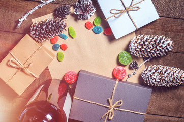 Boxes with gifts, cones, candies and marmalades, free space  on a wooden background