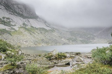 Foggy and cloudy landscape, Mountains, Lake, Clouds. National Park Ergaki, Siberia, Russia