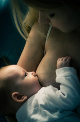 Breastfeeding baby. Mother nursing her child. Newborn eat breast milk.