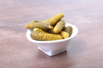 Pickles. Bowl of pickled gherkins cucumber with copy space. Cornichons.