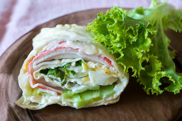 Fresh vegetable salad and meat roll.