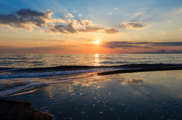 Fototapeta na wymiar Sunset on sea beach
