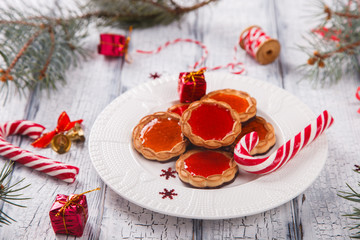 Christmas Baking Cookies with Marmalade on White Wooden Background with crackling effect.Traditional Sweets cane.Holiday card.selective focus