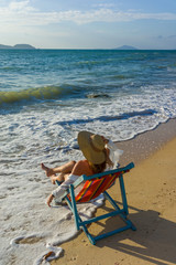 woman relaxing  on sun bed sofa lounge chair on holidays