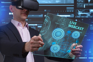 Business, Technology, Internet and network concept. Young businessman working in virtual reality glasses sees the inscription: Live webcast