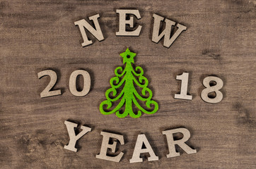 Green Christmas tree and sign 2018 New year from wooden letters, symbol of wooden texture background. Happy new year 2018 backdrop.Greeting card