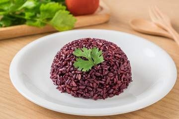 Black rice cooked on white plate