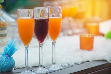 Glasses of wines and orange juice on table for evening party