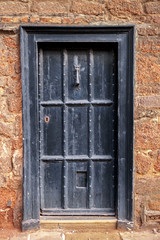Fototapeta na wymiar old wooden door with vintage rustic knocker knob, Exeter, UK, February 18, 2017
