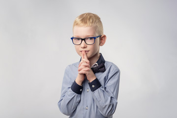 Caucasian teenager with blond hair and glasses thinking isolated on white background