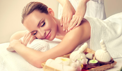 Fototapeta na wymiar Massage and body care. Spa body massage treatment. Woman having massage in the spa salon for beautiful girl 