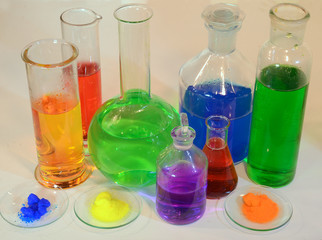 Colorful liquids and powders in laboratorium glassware.