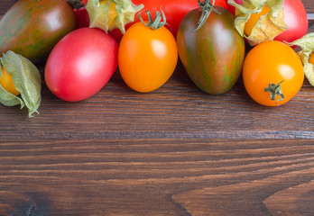 tomatoes and gooseberry on wooden table top side