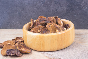 Dried forest mushrooms on a wooden table.