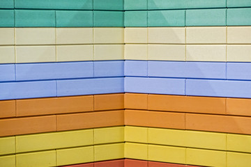 Abstract colorful brick wall pattern painted bricks urban texture background. Example of a colored brick wall at the exhibition