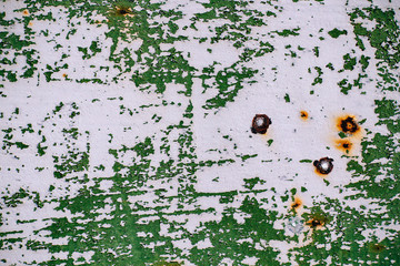  gray painted metal wall with cracked green paint, rust stains, sheet of rusty metal with cracked and flaky green paint , metal background for design with copy space