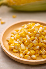 Sweet corn seeds on a wooden plate