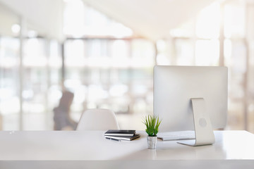 Stylish workspace with desktop computer, office supplies, houseplant and books at office. desk work concept.