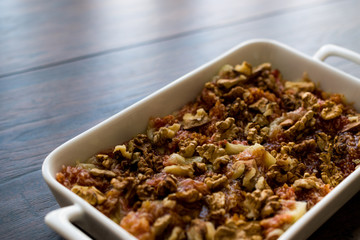 Figs with hazelnuts in a white tray.