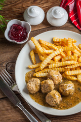 Meatballs with french fries in dill sauce.