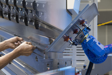 The abstract scene of automatic robot arm  and human hand. Industrial 4.0 concept.Modern technology...