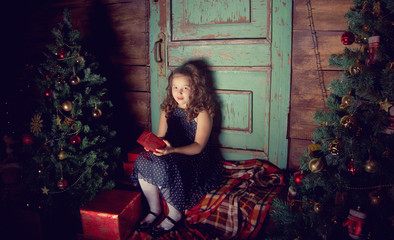 Happy little girl  decorate Christmas tree