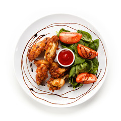 Grilled chicken drumsticks on white background 