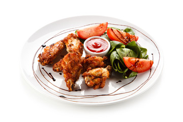 Grilled chicken drumsticks on white background 