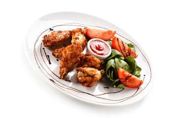 Grilled chicken drumsticks on white background 