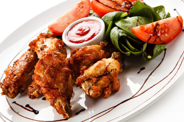Grilled chicken drumsticks on white background 