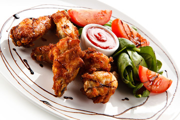 Grilled chicken drumsticks on white background 