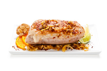 Roast ham with vegetables on white background