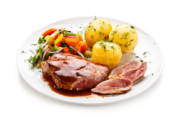 Grilled steak with vegetables on white background