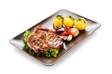 Roast steak with potatoes on white background