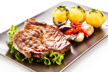 Roast steak with potatoes on white background
