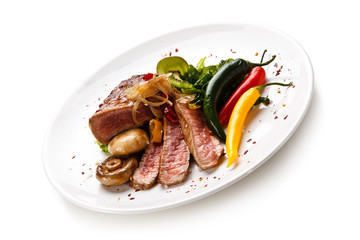     Fillet mignon - grilled beefsteaks with vegetables on white background 