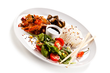 Rice dish with goulash on white background 