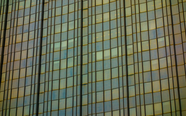 darken glass facade with yellow windows