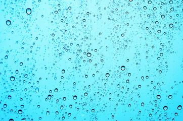 Water droplets on a blue background.