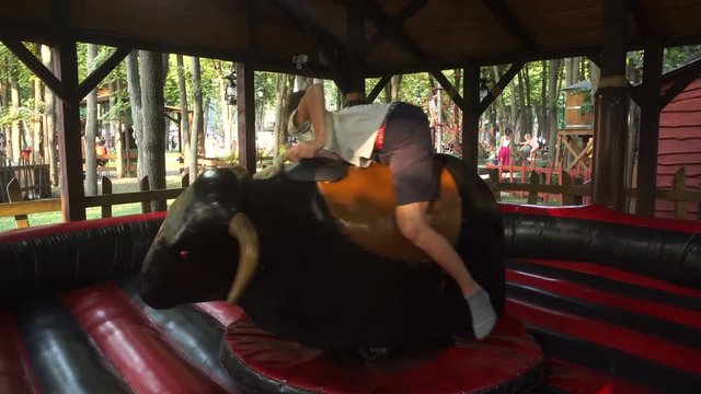 Guy riding a mechanical bull ride