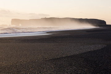 Cape Dirholaey in southern Iceland during sunset on a foggy day