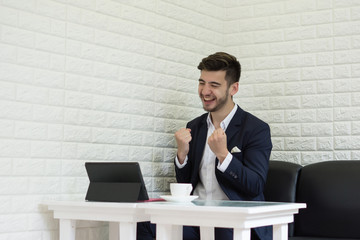 Successful Young businessman working on laptop at office.