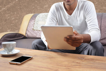 Man using tablet pc with blank mobile screen on the table