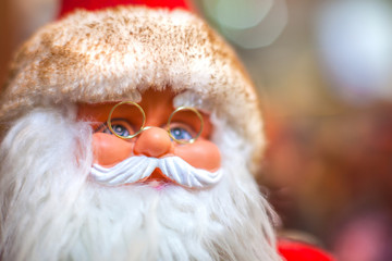 Toy Santa Claus on Christmas tree background in Christmas. Happy New Year.