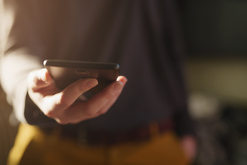 young girl holding smartphone while standing indoor