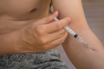 Men with needle to prick, medicine and health.