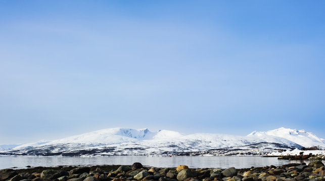 Coast line by the mountains in Troms&oslash;