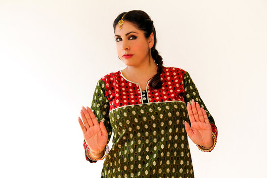 Woman dancing Indian dance in national dress. A beautiful girl portrait in shree kurta patiala set style, horn for the Indian dance movement. Indian dancer in traditional clothing. Bollywood dance.