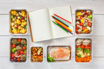 Healthy food take away in boxes, top view at wood