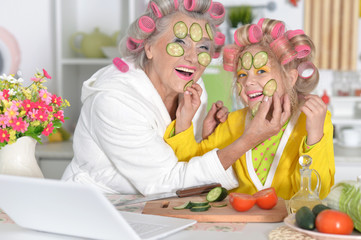 woman and girl making mask from cucumber 